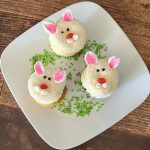 Picture of cupcakes on a plate decorated like bunny rabbits.